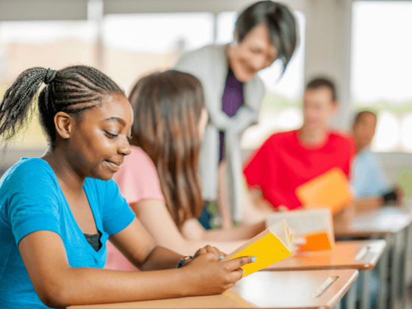 A classroom with a teacher talking to her students.