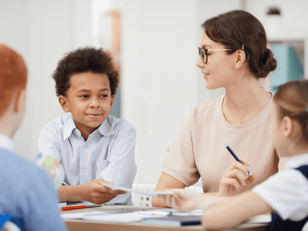 A teacher encouraging group work.