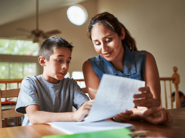 A teacher working one-on-one with a student.