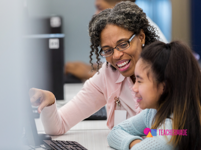 A teacher working with a young learner in front of a computer.